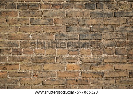 old red brick wall showing signs of age and decay.