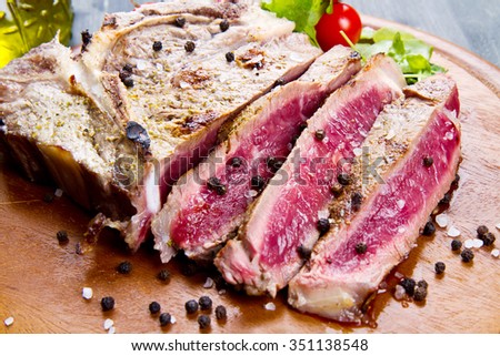 grilled sliced meat fillet on wooden background
